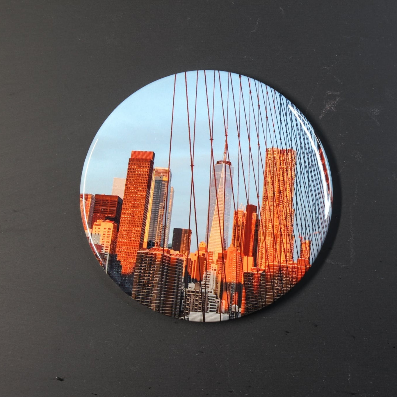 Circular sticker with cityscape design on a dark background