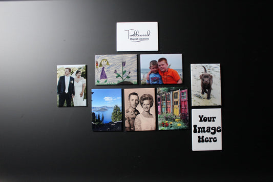 Collection of custom photo magnets showing family photos, pets, kids drawings, and outdoor photos on a black surface with 'Framed Memories' branding.