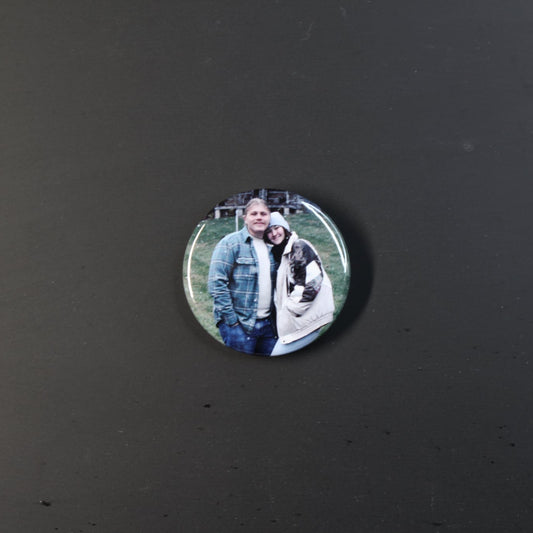 Circular photo badge of two people on a dark background